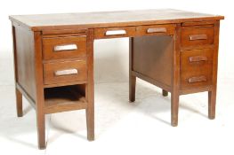 A retro vintage mid century oak air ministry twin pedestal office desk having a wooden top with pull