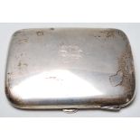 A silver hallmarked cigarette case of square form having rounded corners with engraved initials to