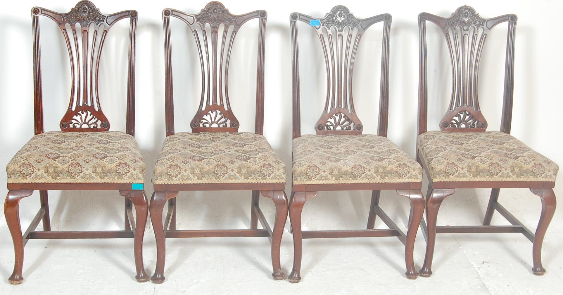 A set of four early 20th Century Edwardian dining chairs in the manner of hepplewhite having pierced