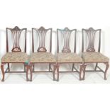A set of four early 20th Century Edwardian dining chairs in the manner of hepplewhite having pierced