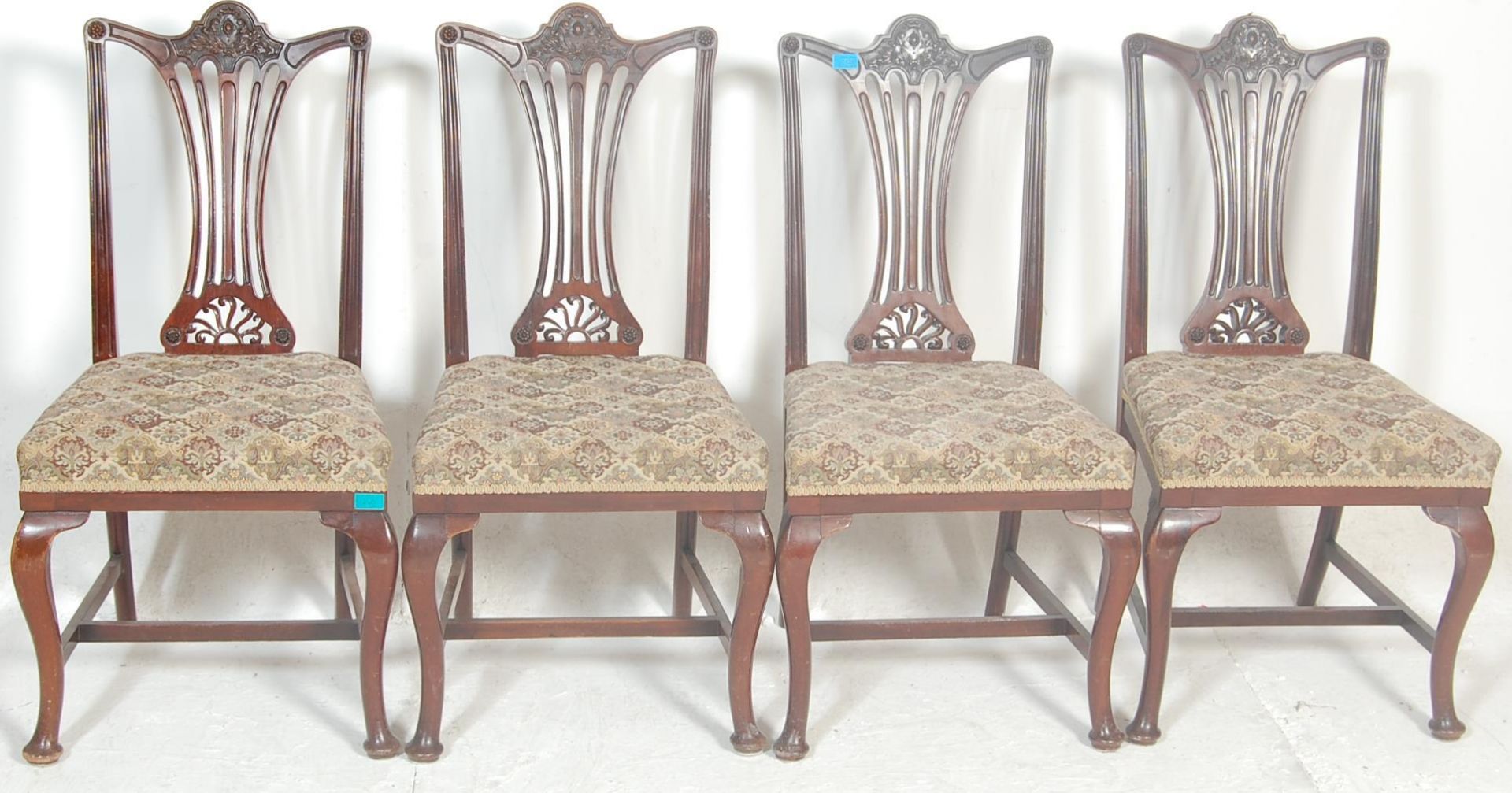 A set of four early 20th Century Edwardian dining chairs in the manner of hepplewhite having pierced