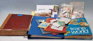 A collection of world postage stamps across multiple items to include a wide selection of mid to