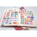 A collection of vintage 20th Century world stamps in red albums dating from the early 20th Century