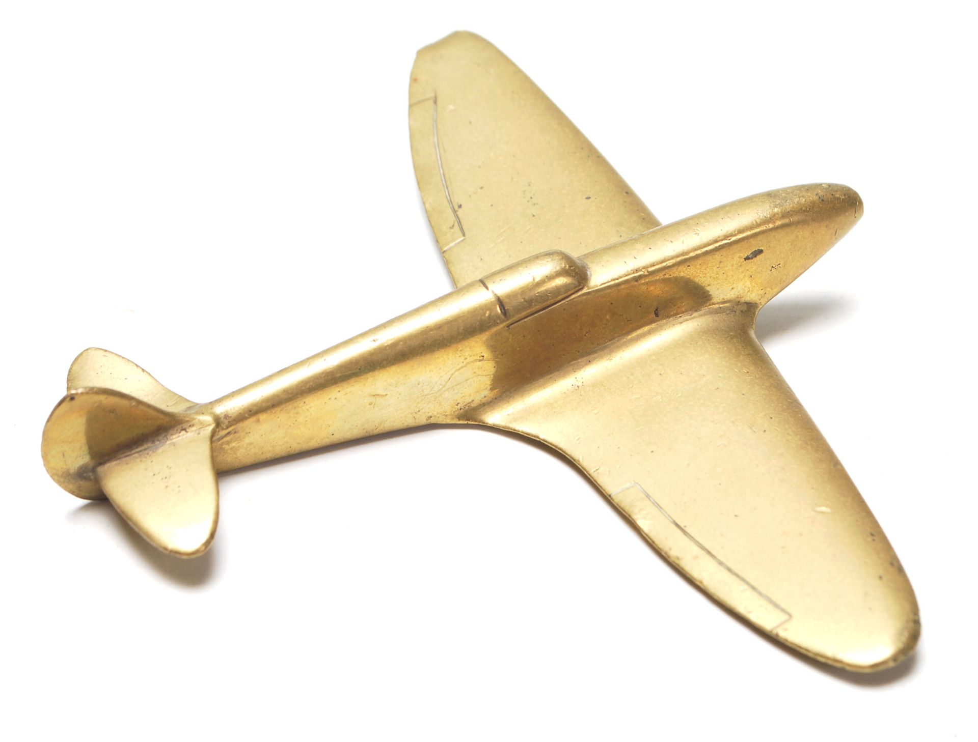 A WWII hand made trench art brass model Spitfire plane. Measures 12.5 x 15cm. Of military interest.