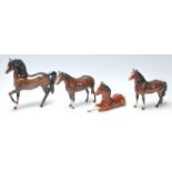 A collection of three vintage mid century Beswick horses finished in dark brown colour, white