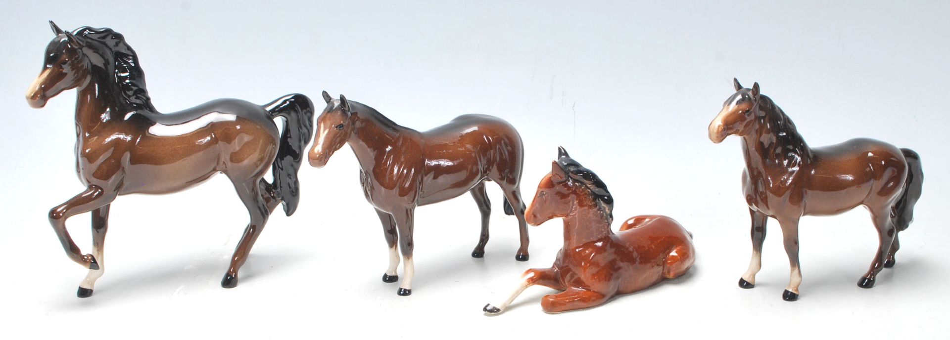 A collection of three vintage mid century Beswick horses finished in dark brown colour, white