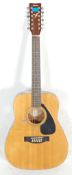 A vintage Yamaha FG 410 12A twelve string acoustic guitar instrument having the Yamaha stamp to