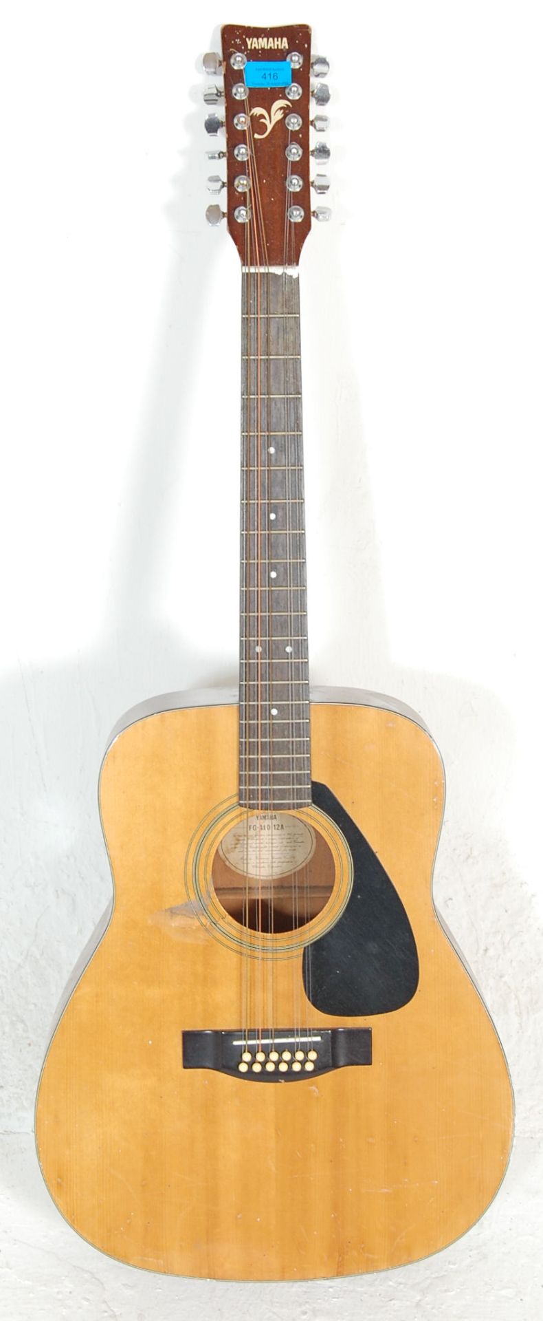 A vintage Yamaha FG 410 12A twelve string acoustic guitar instrument having the Yamaha stamp to