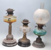 A group of three 19th century Victorian oil lamps to include one having a ceramic base with brass