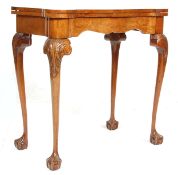 An 18th Century style walnut 20th Century ' dog ear '  folding card / games table on cabriole legs