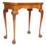 An 18th Century style walnut 20th Century ' dog ear '  folding card / games table on cabriole legs