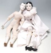 Two vintage porcelain French Pierrot dolls, having porcelain head, hands, and legs having hand-
