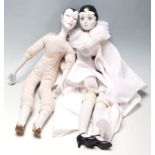 Two vintage porcelain French Pierrot dolls, having porcelain head, hands, and legs having hand-