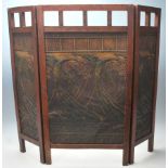 A 1920’s Arts & Crafts oak triptych fire screen guard  having articulated side panels with pierced