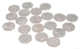 A group of twenty Queen Elizabeth II 50p coins to include Beatrix Potter coins, Paddington bear,