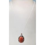 A large silver pendant necklace having a cased agate stone with a stamped .925 cable chain and a