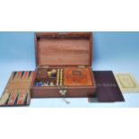 An early 20th Century wooden games compendium box being fully appointed with retro games to