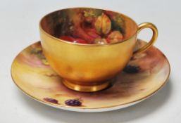 A Royal Worcester porcelain hand painted cup and saucer one decorated with peaches and