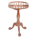 A Victorian 19th Century mahogany style wine table having a spindle gallery top above a turned