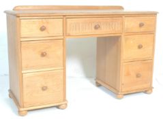 A good 20th Century light oak kneehole  twin pedestal desk,having carved central kneehole drawer