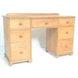 A good 20th Century light oak kneehole  twin pedestal desk,having carved central kneehole drawer