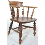 An antique 19th Century Victorian beech and elm smokers bow chair / armchair having a spindle back