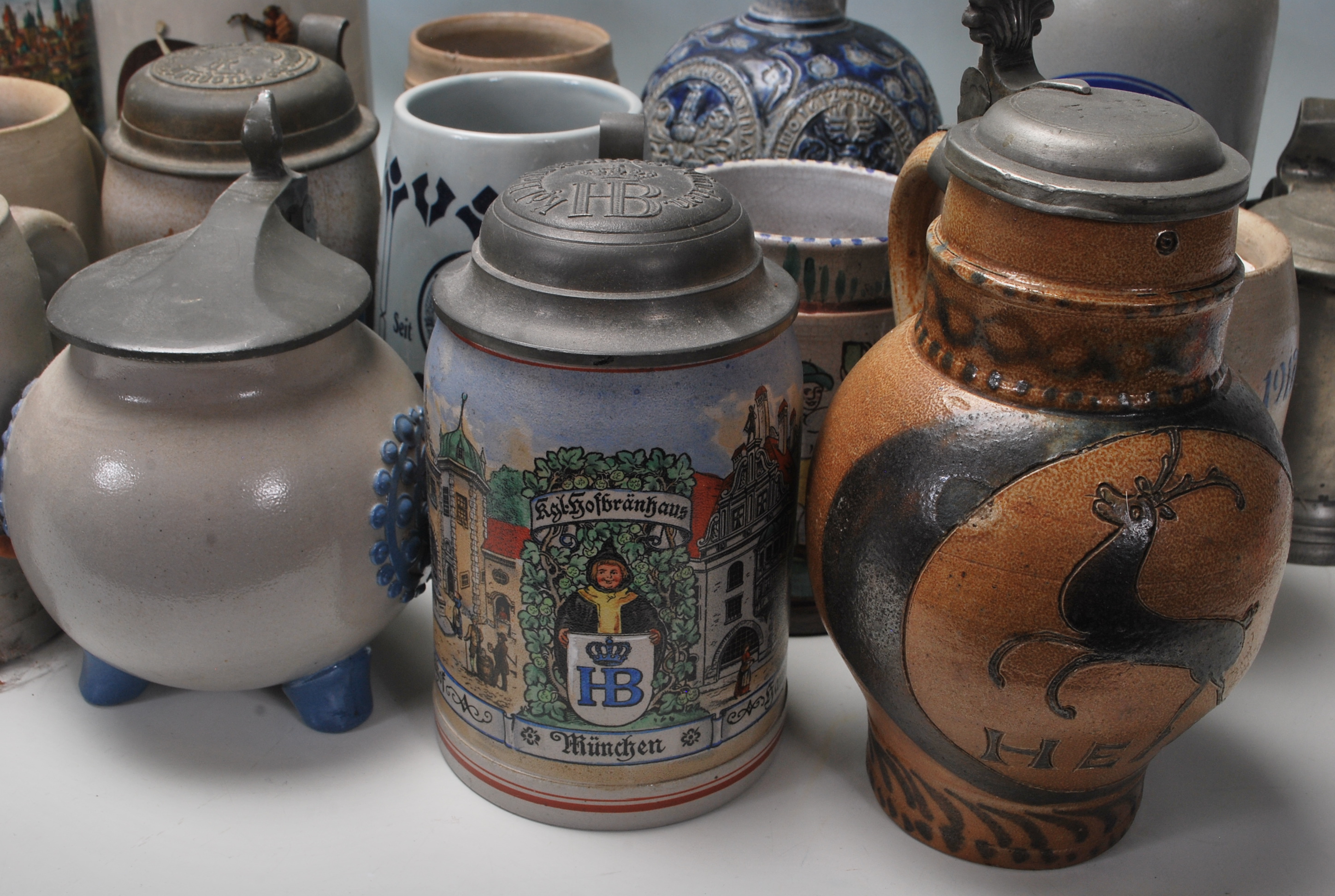 A large collection of German blue and grey stoneware jugs and beer steins, some having pewter - Image 3 of 10