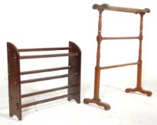 An early 20th Century arts and crafts bookshelf having panelled supports with square block stretcher