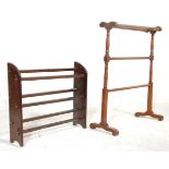 An early 20th Century arts and crafts bookshelf having panelled supports with square block stretcher