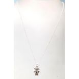 A stamped .925 silver pendant necklace in the shape of a child's doll having a .925 cable chain with