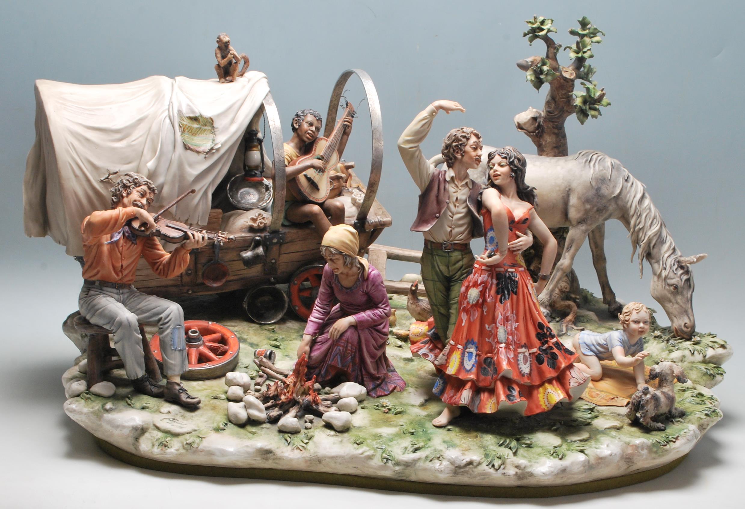 A very large 20th century Capodimonte centrepiece figurine group 'The Gypsy Encampment by Sandro