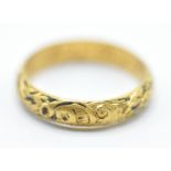 An early 18th Century gold memento mori mourning ring, the band being engraved with a skull and