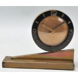 A 1920's Art Deco 8 days mantel clock having a round case with black enamelled case with arabic