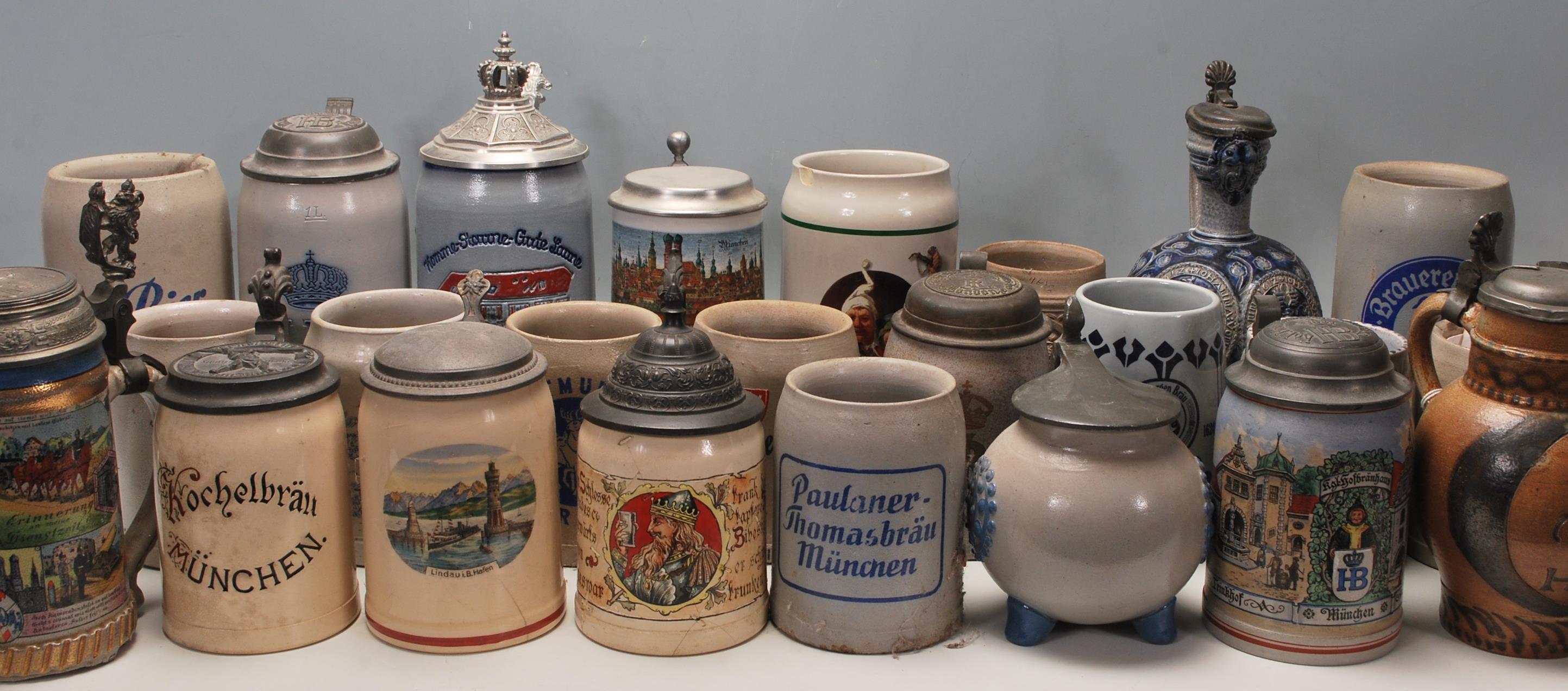 A large collection of German blue and grey stoneware jugs and beer steins, some having pewter