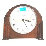 A retro vintage 1930s oak art deco mantel clock by Kemp Brothers having a dome shaped top set on