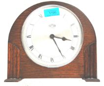 A retro vintage 1930s oak art deco mantel clock by Kemp Brothers having a dome shaped top set on