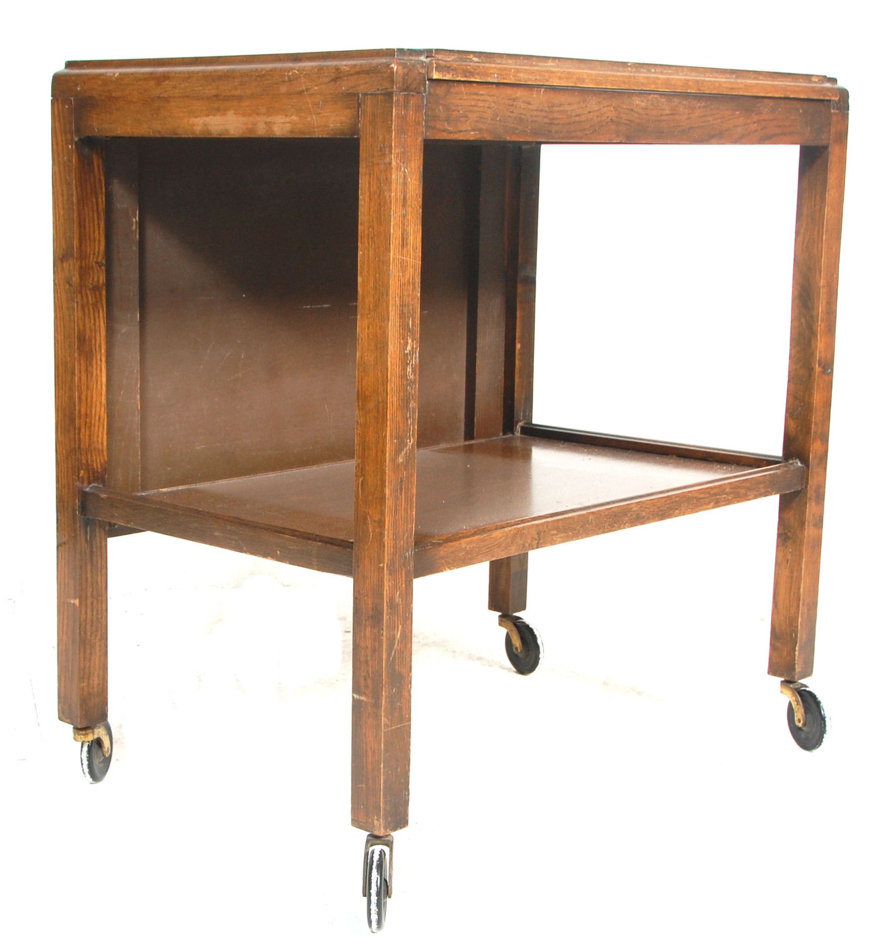 A vintage oak 1930s' butlers drinks / tea trolley having two rectangular tiers with a metamorphic