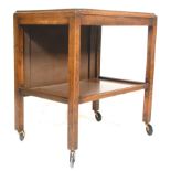 A vintage oak 1930s' butlers drinks / tea trolley having two rectangular tiers with a metamorphic