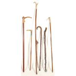 A collection of mixed 20th Century walking stick canes to include four walking sticks with horn