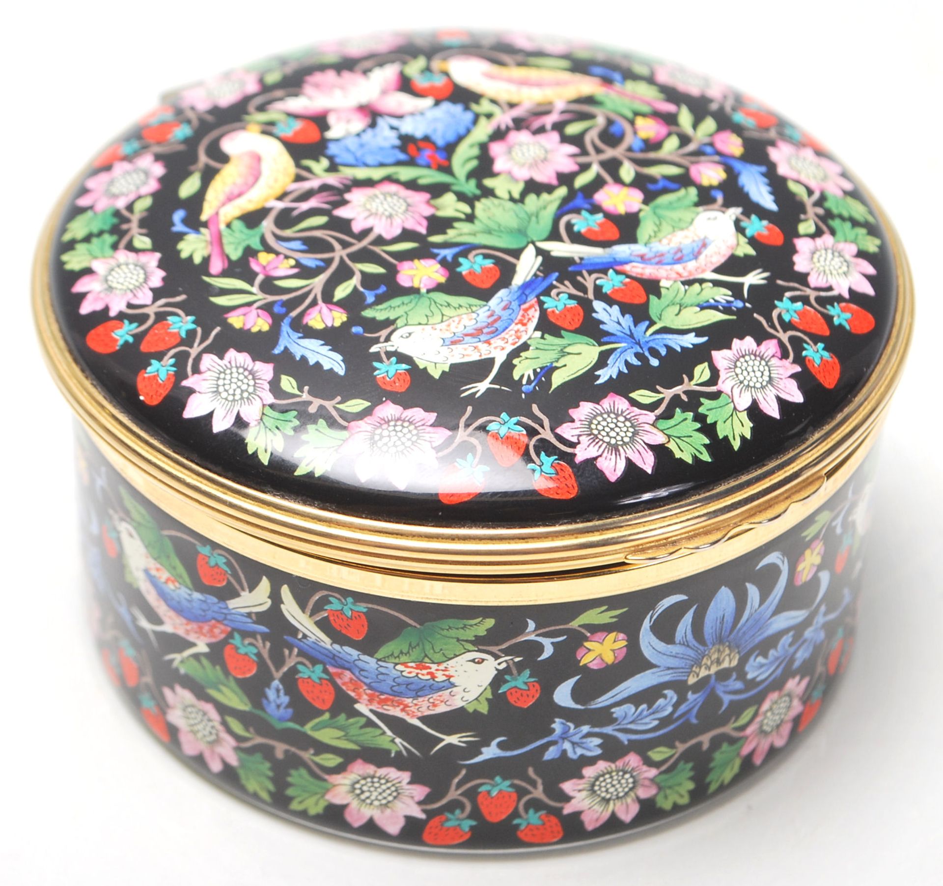 A vintage Halcyon Days Enamels musical box has decoration after “ The Strawberry Thief “ by