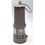 A 19th century Victorian miners lamp with hook swing handle, brass and metal body united by rivets