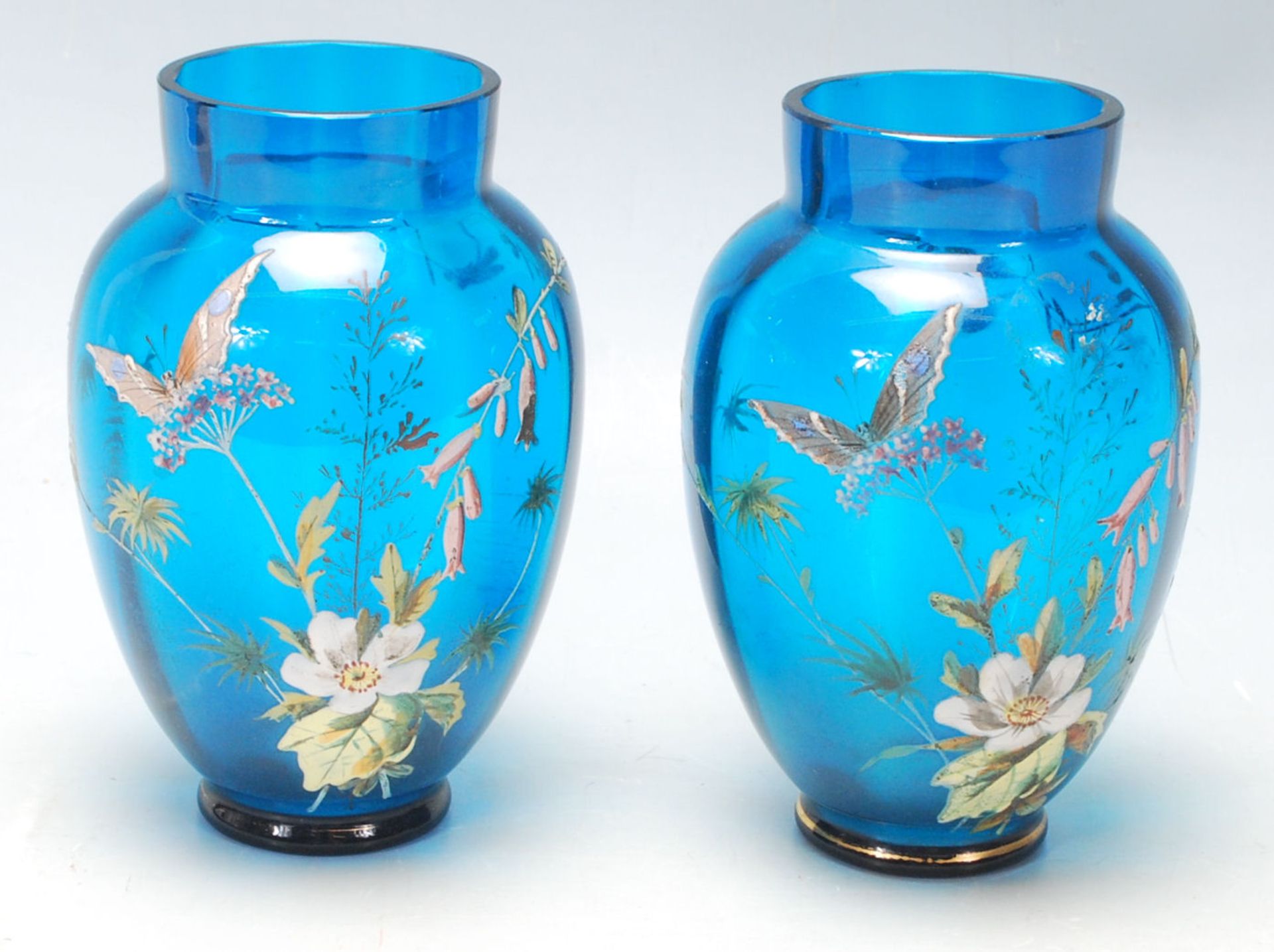 A pair of 19th Century Victorian Aesthetic Movement hand painted blue glass vases having a ribbed