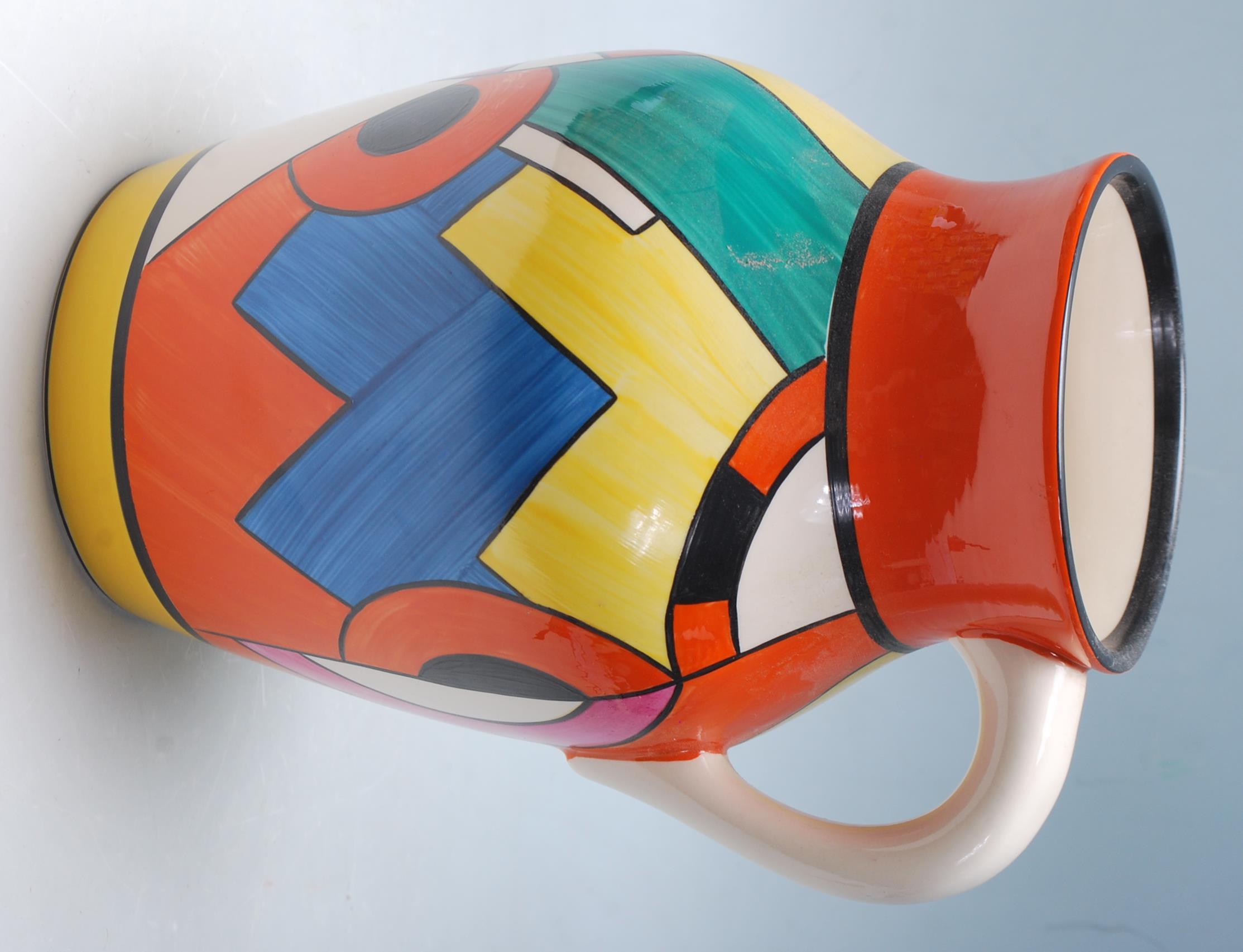 A Wedgwood Bizarre by Clarice Cliff Blue 'W' jug being hand painted with geometric decoration to the - Image 5 of 14