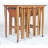 A retro vintage 1970's danish inspired drop leaf teak veneered quartetto nest of tables featuring