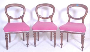 A set of three Victorian 19th century mahogany balloon back dining chairs having scroll carved back,