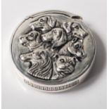 A silver plated vesta case of circular form with an embossed image of various breeds of dogs and