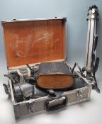 A collection of vintage cameras and related equipment to include a flight case, tripod, Canon A-1, a