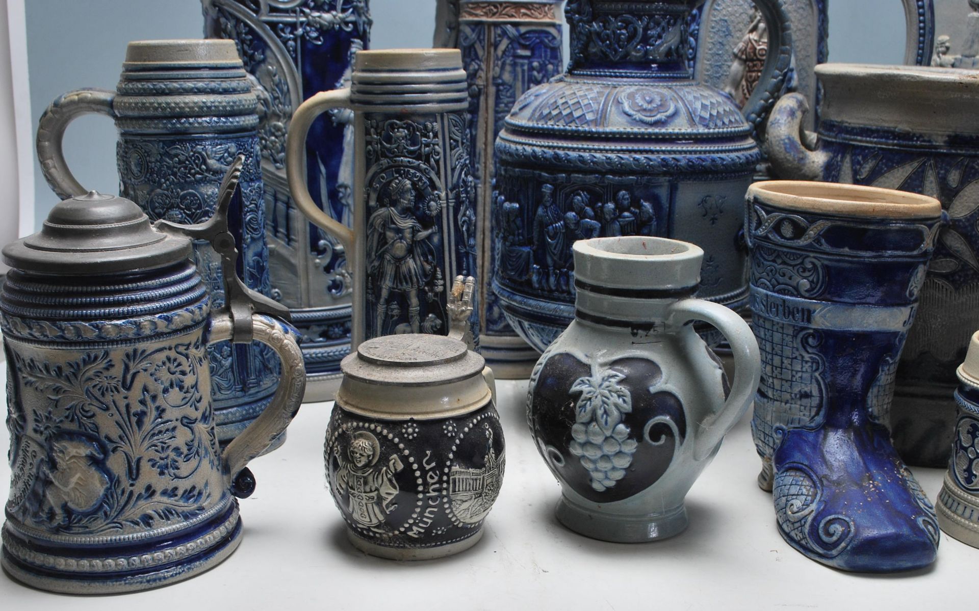 A collection of 20th Century German ceramic stein drinking glasses, each having raised decoration to - Bild 2 aus 7