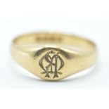 A late 19th / early 20th Century 18ct gold signet ring having a round head engraved with initials.