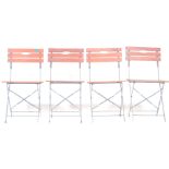 A set of four vintage 20th century French folding cafe chairs with painted banded metal frames and